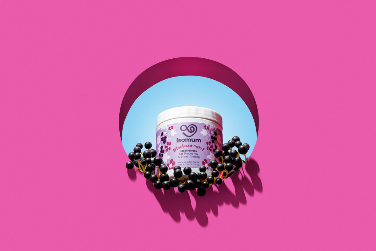 Styled photo of a pot of isomum with blackcurrants